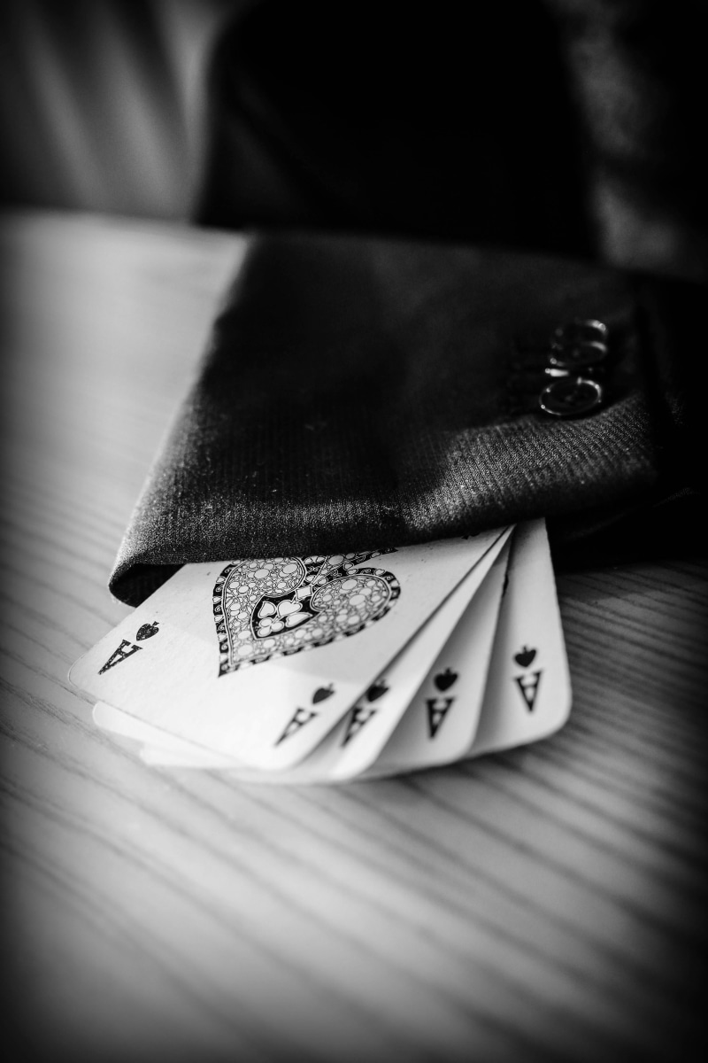 wood, auto post production filter, close-up, western script, sleeve, art and craft, creativity, currency, cards, black and white, cheat, table, selective focus