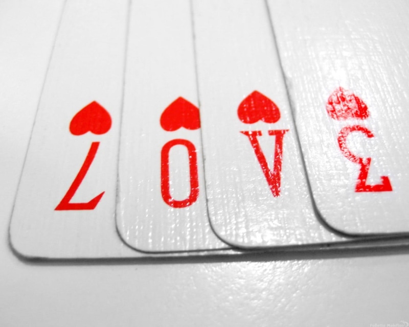 playing cards, text, handwriting, positive emotion, message, playing, red, no people, food, love, food and drink, capital letter, indoors, paper, single word