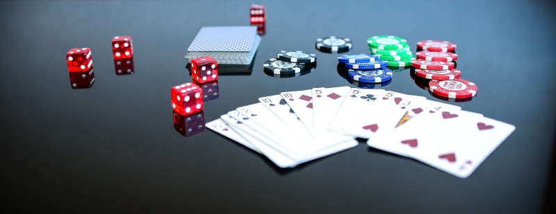 high angle view, large group of objects, gambling chip, no people, black background, coin, choice, ace, dice, opportunity, cubes, blur, playing cards, poker chips