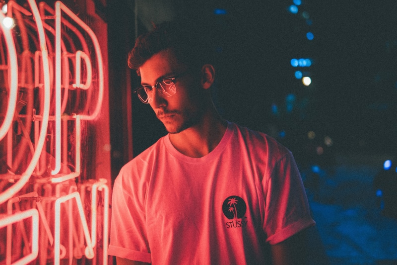 front, night light, t-shirt, near, standing, 5K, front view, man, blue, light, pink, focus on foreground, lifestyles, portrait, signage, neon light, red