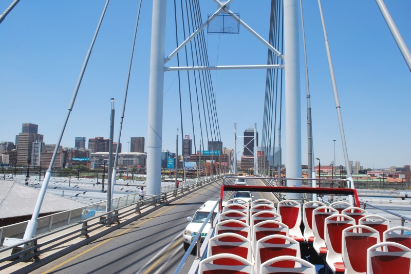 Nelson Mandela Bridge, outdoors, suspension bridge, nautical vessel, nature, in a row, built structure, red, bridge - man made structure, cityscape, connection