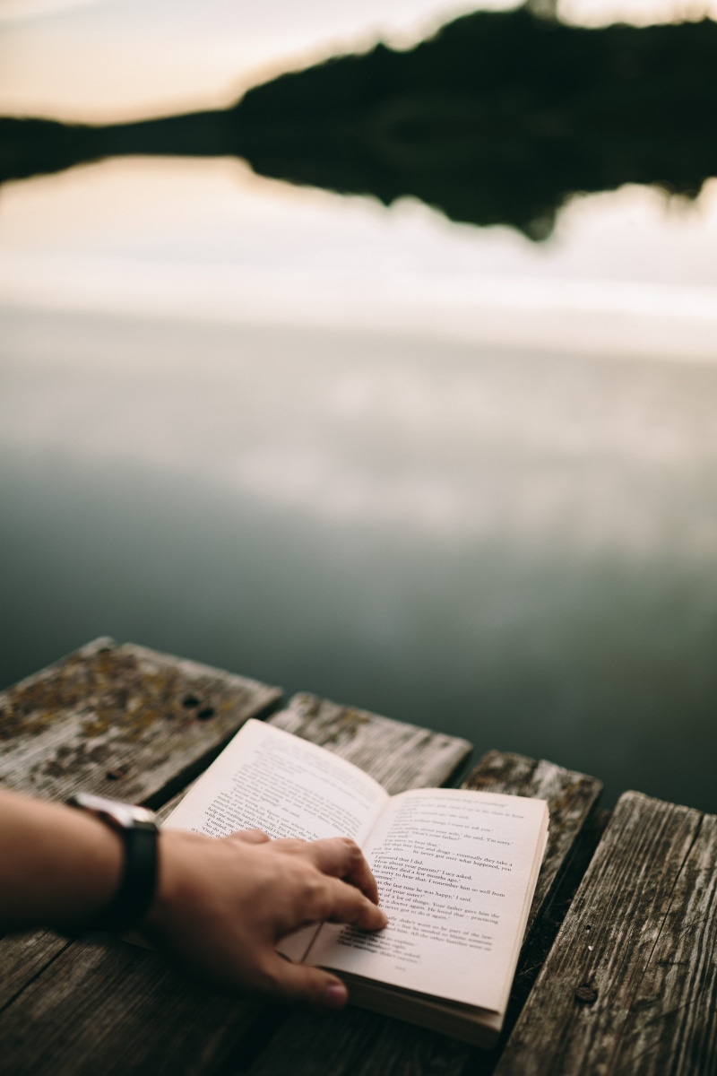 girl reading book, relaxing, water, only women, one woman only, wood - material, outdoors, human Hand, religion, people, time, christianity, spirituality