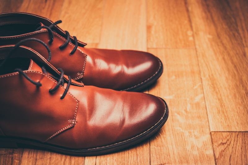 wood - material, human foot, shoestring, work shoes, human limb, flooring, mens shoes, lace-up boots, dress shoe, pair, indoors, fashion, eyelets, human leg