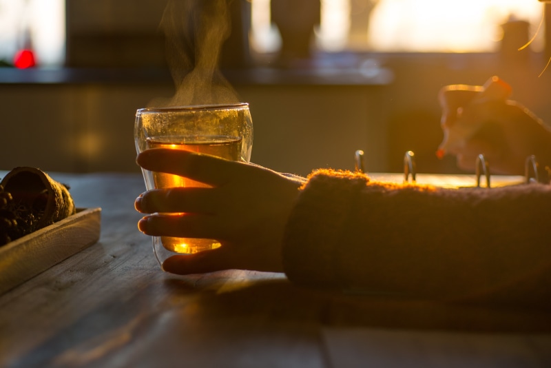 finger, wood - material, home, indoors, glass, tea, human hand, table, celebration, beverage, illuminated, studying, person, refreshment, holding, bar - drink establishment