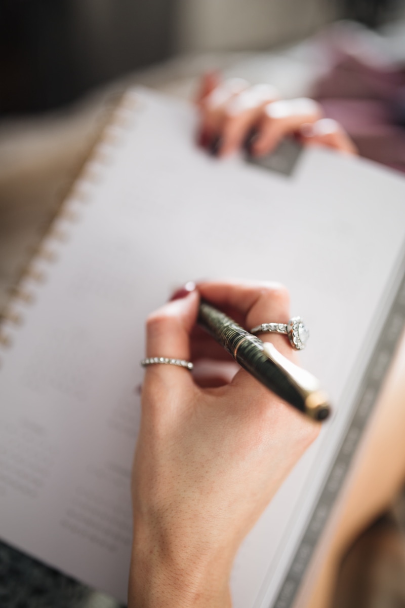 human body part, notebook, focus on foreground, close-up, woman, high angle view, human hand, women, work, cosy, selective focus, holding, writing, accuracy
