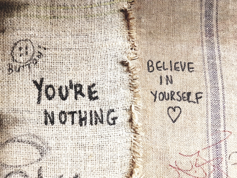 e, symbol, motion, full frame, paper, believe, close-up, no people, directly above, information, sacks, western script, non-western script, black, text