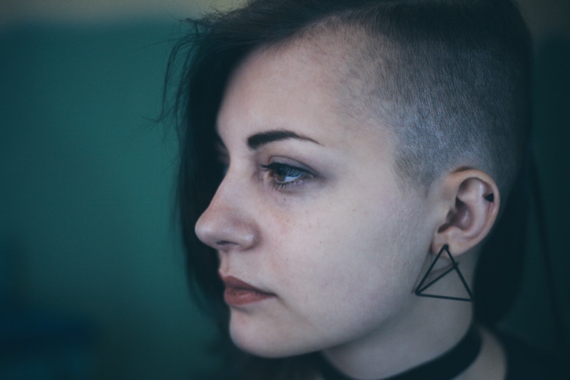 woman, black hair, women, one person, introspection, right, young women, focus, earring, indoors, facing, hair, hairstyle, wearing, profile, triangle, looking away