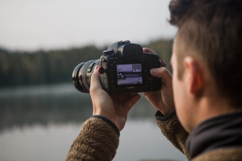 holding, 5K, lifestyles, adult, headshot, nature, camera - photographic equipment, selective focus, tree, people, lake, water, rear view, modern, man