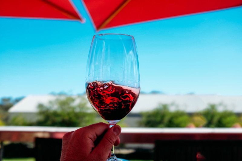 focus on foreground, alcohol, red Wine, human hand, freshness, blue sky, wine, red, holding, hand, drinking Glass, travel, transparent, blue, finger, drinks