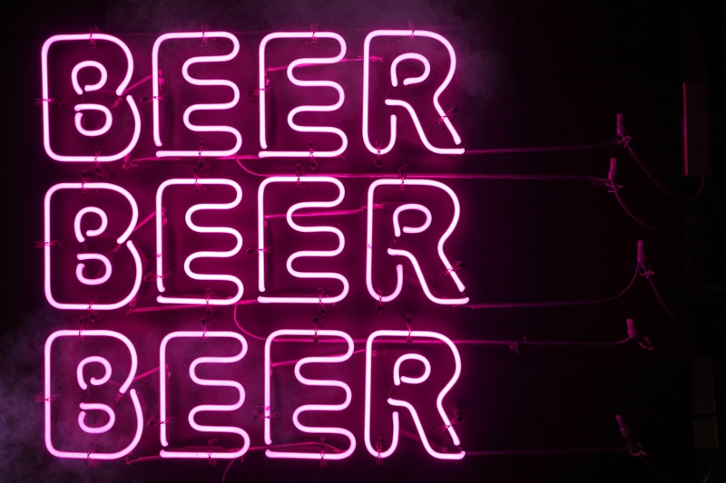 musical instrument, clothing, neon, poster, number, lighting equipment, sign, text, glowing, night, beer, close-up, western script, hood, lab coat, signage