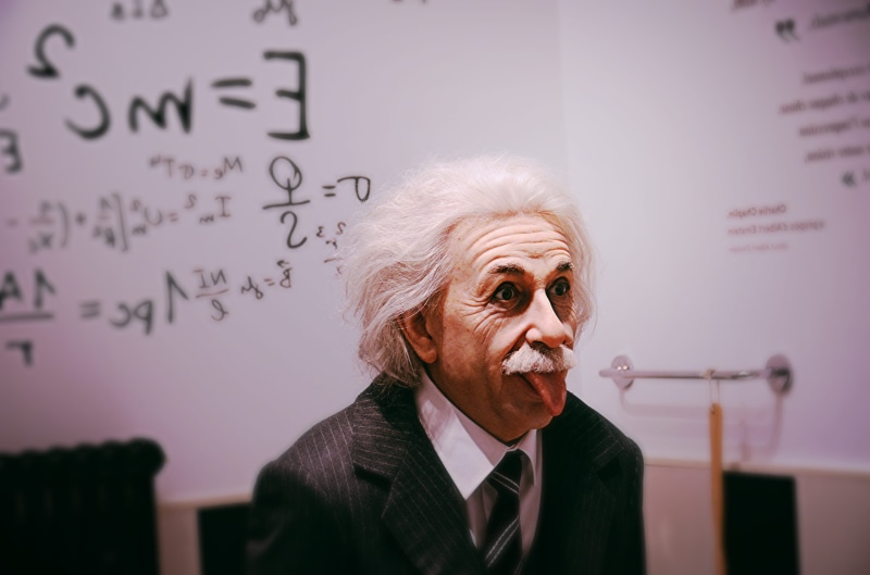 occupation, business, senior adult, suit, white hair, senior citizen, front view, indoors, board, text, handwriting, sitting, clothing, face, accessories
