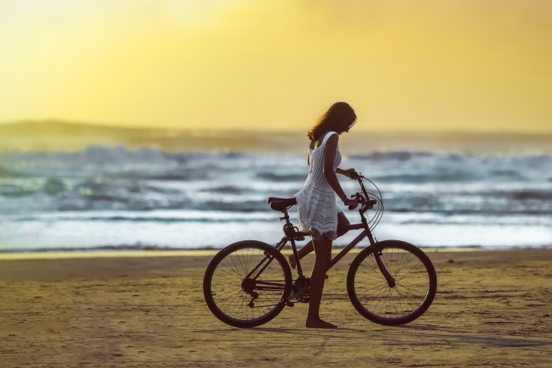 beauty in nature, model, land, horizon over water, wave, water, 1080P, women, sand, outdoors, one person, bicycle, real people, horizon, leisure activity