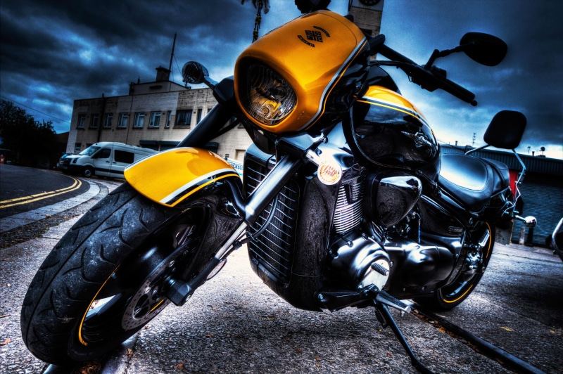 bike, road, sky, outdoors, headwear, cloud - sky, crash helmet, helmet, dusk, bike riding, black, stationary, yellow, land vehicle, sports helmet, extreme sports