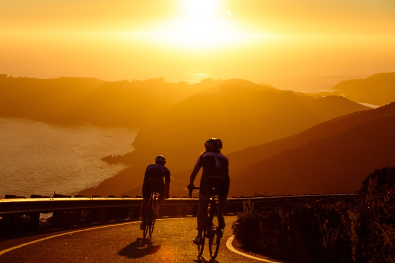 leisure activity, beauty in nature, fit, travel, bicycles, sunlight, sun, landscape, light, men, scenics - nature, adults only, bridge - man made structure