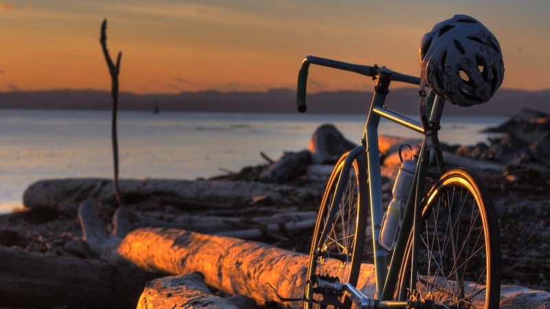 close-up, no people, vehicle, gray, beauty in nature, transportation, beach, fixie, sky, bike, outdoors, sea, helmet, landscape, land vehicle, metal, sunset