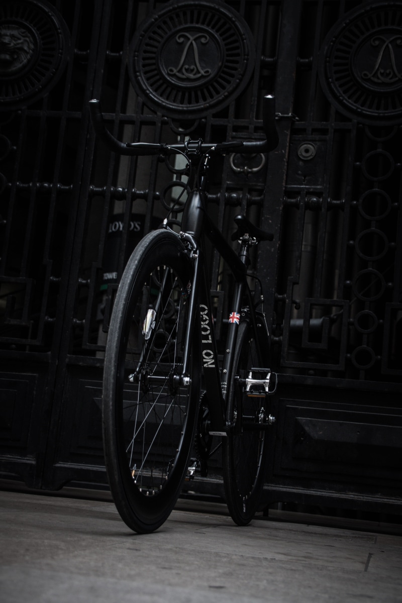 parking, wheel, metal, architecture, land vehicle, 5K, no people, road, mode of transportation, bike, black, bike rack, close-up, city, built structure