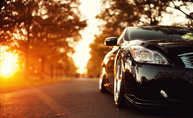sky, focus on foreground, Trees, sunset, Landscape, sunlight, architecture, Black, Road, street, retro styled, land vehicle, car, 2K, silver colored, city