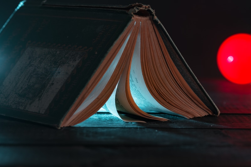 without a filter, paper, red, single object, texture, book, wisdom, old, indoors, no people, abstract, 5K, close-up, light, transparent, knowledge, table