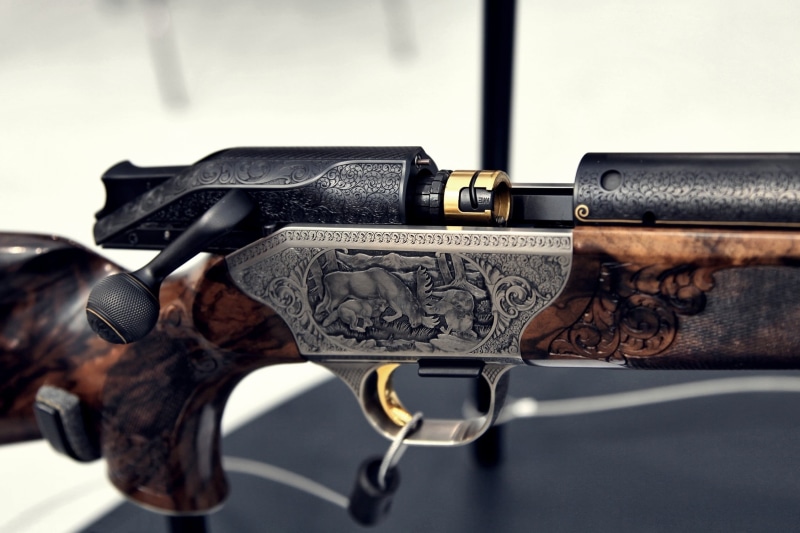 handgun, technology, still life, focus on foreground, military, gun, protection, gray, government, indoors, rifle, brown, day, black color, no people, sign