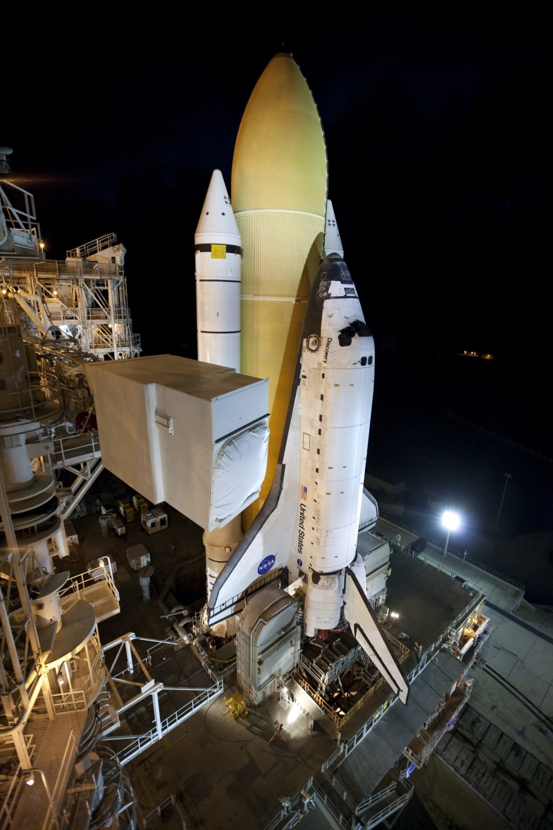 architecture, air vehicle, machinery, transportation, night, aerospace industry, launch pad, outdoors, pre-launch, airplane, rollout, nature, discovery space shuttle