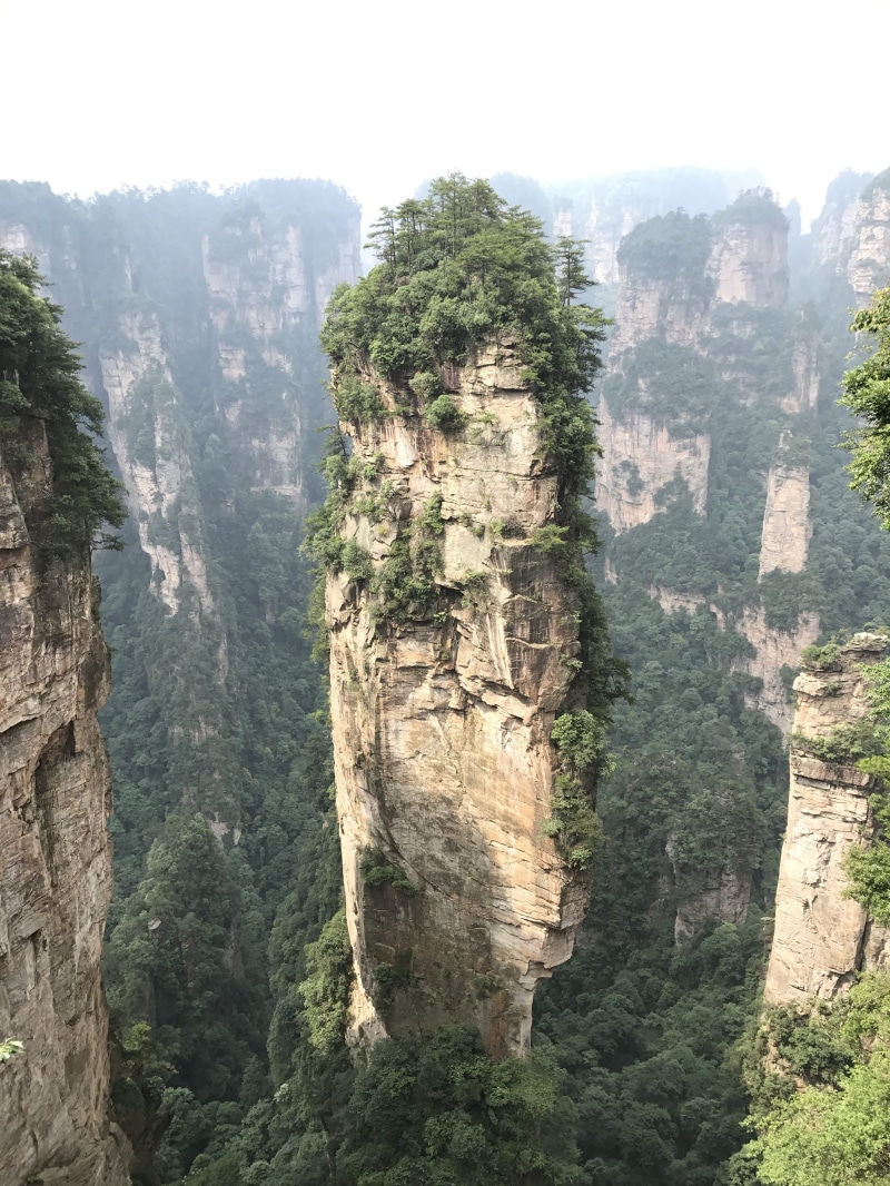 solid, stone, rock, tall, travel destinations, beauty in nature, tranquility, rock - object, day, nature, mountain, rock formation, zhangjiajie, plant