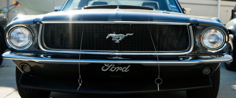 front view, 2K, Ford Mustang, old car, day, vintage car, chrome, outdoors, metal, focus on foreground, wheel, car, ford mustang 1969, headlight, muscle cars