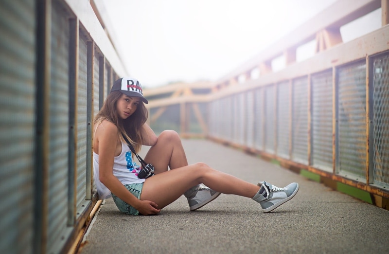 white, casual clothing, young adult, hair, bridge, full length, day, jean shorts, leisure activity, green, young women, women, looking at camera, real people