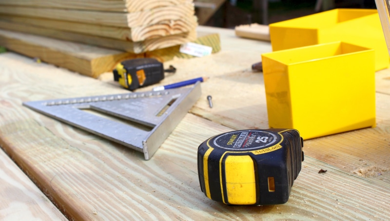 equipment, focus on foreground, tool, two, measurer, day, workshop, building - Activity, close-up, triangular, stainless, one man only, builder, people