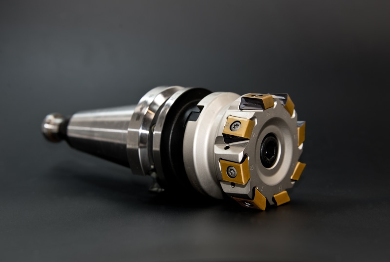black background, grey, metal, studio shot, technology, milling machine, manufacturing, drilling head, gray, gold colored, number, communication, mechanics