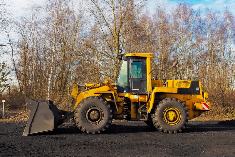tree, land, yellow, industry, metal, earthmoving, truck, day, end, tire, machinery, work machine, stationary, motor vehicle, blade, transportation, land vehicle