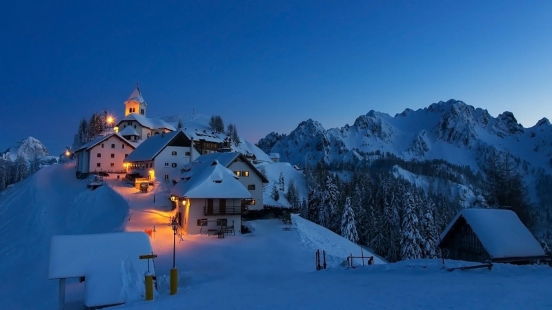 piste, monte lussari, house, beauty in nature, built structure, dusk, sky, mountainous landforms, cold temperature, freezing, illuminated, blue, residential district