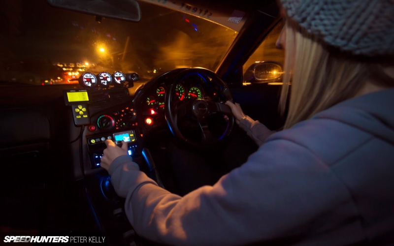 indoors, 1080P, woman, vehicle interior, vehicle, illuminated, control panel, technology, travel, adult, mode of transportation, holding, pilot, car interior