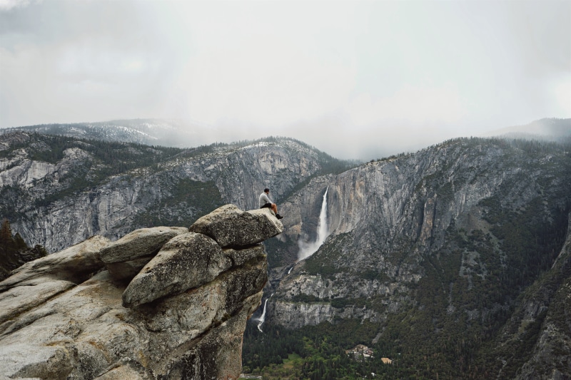mountain range, the finger, human arm, hald dome, nature, stream, beauty in nature, rock, man, day, men, scenics - nature, sitting, rain, one person, climbing