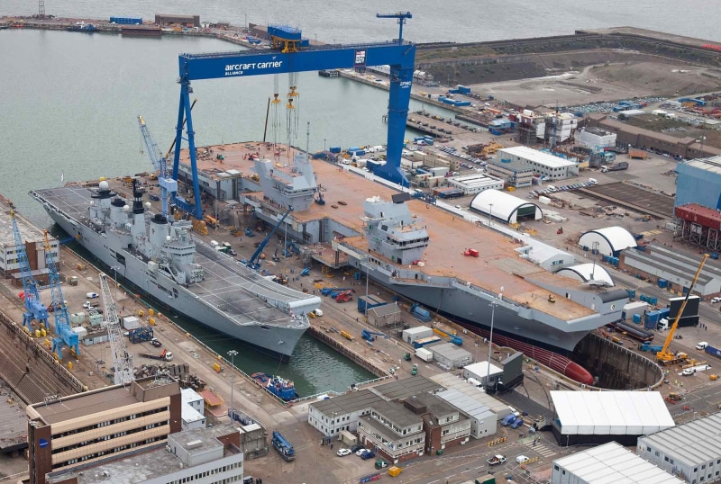 vehicle, outdoors, military, industry, cityscape, day, Queen Elizabeth-class aircraft carrier, water, ship, roof, nautical vessel, architecture, bow, warship