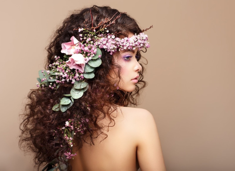 contemplation, pink, looking at camera, floral, indoors, adult, leaves, beauty, beige background, face, headshot, simple background, headdress, flowering plant
