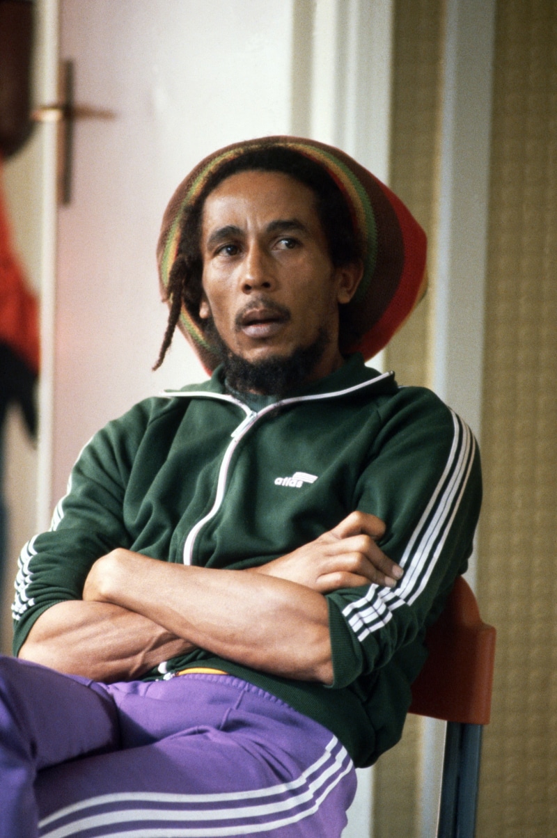 music, Bob Marley, looking, 2K, front view, men, indoors, sitting, holding, serious, contemplation, celebrity, waist up, one person, mature adult, sport
