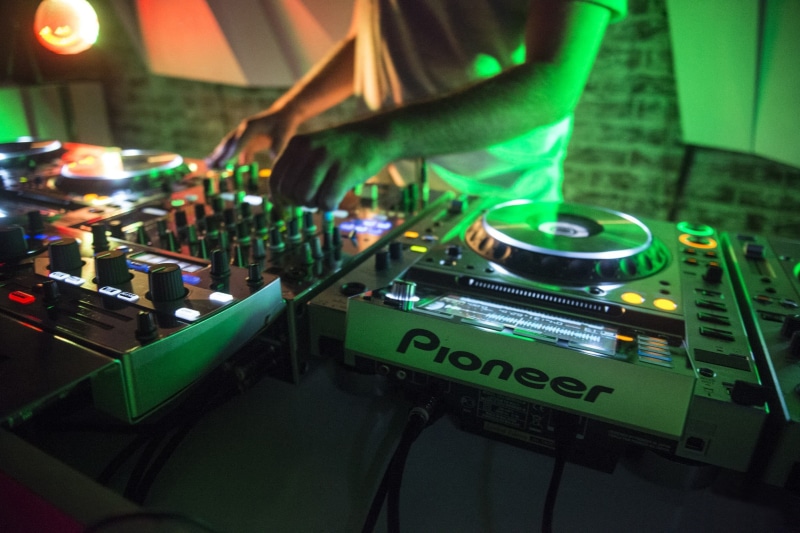 white, indoors, equipment, hand, turntables, nightclub, sound recording equipment, DJ, arts culture and entertainment, green color, turntable, real people