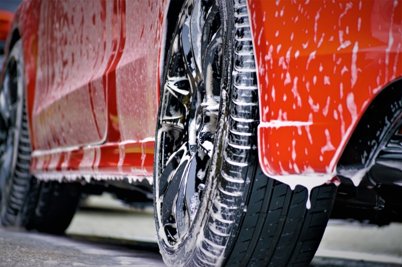 black color, car cleaning, land vehicle, red car, shampoo, car shampoo, wheel, transportation, mode of transportation, motor vehicle, car wash, red, city