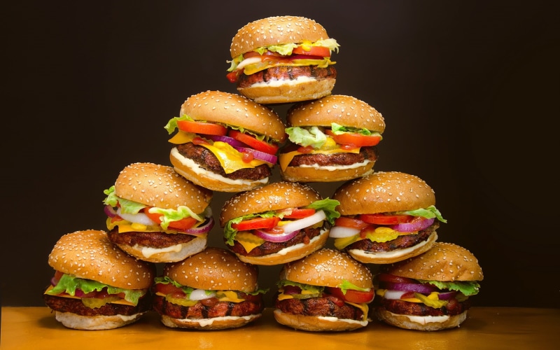 vegetable, fast food, indoors, tomatoes, black background, unhealthy eating, bun, stack, ready-to-eat, food and drink, food, freshness, still life, burger