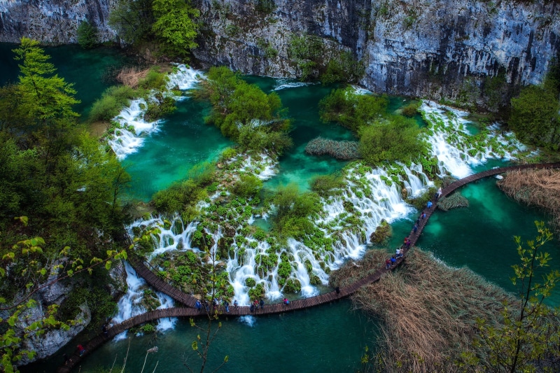 no people, high angle view, outdoors, croatia, flowing, water, tranquil scene, solid, plant, waterfalls, waterfall, rocks, flowing water, rock, green color