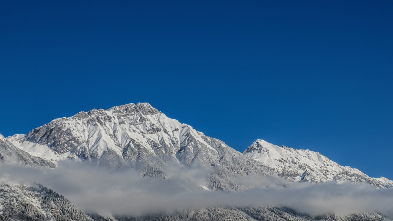 mountain range, coniferous tree, outdoors, no people, sky, mountains, cold, capped, mountain peak, snow, pine woodland, beauty in nature, blue, mountain