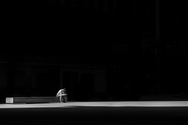 people, unrecognizable person, night, dark, solitude, pets, rest, outdoors, lifestyles, copy space, bench, architecture, road, thinking, rear view, built structure