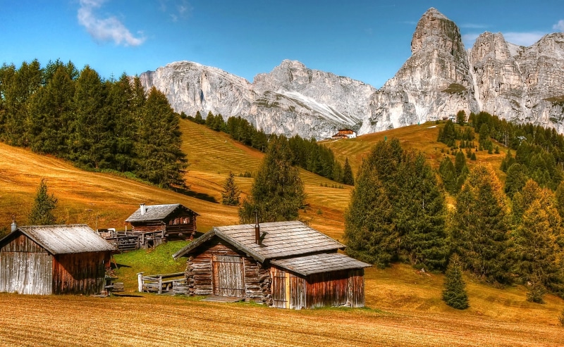 water, nature, unesco world heritage, val gardena, mountain range, blue, mountain, pine tree, clouds, view, brown, land, cabin, building, boulders, architecture