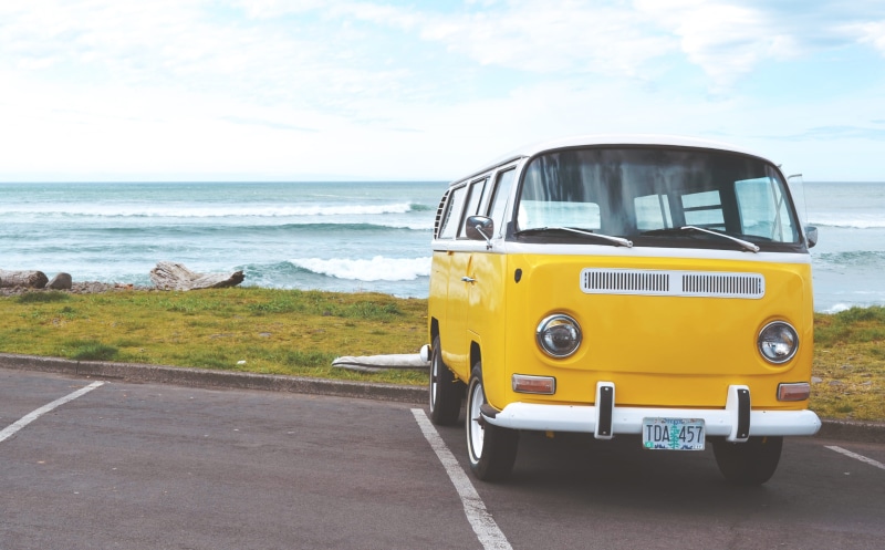 volkswagen, cloud - sky, day, road, horizon, cloudy, concrete, car, beach, vw van, water, no people, travel, sky, shore, ocean, yellow, transportation