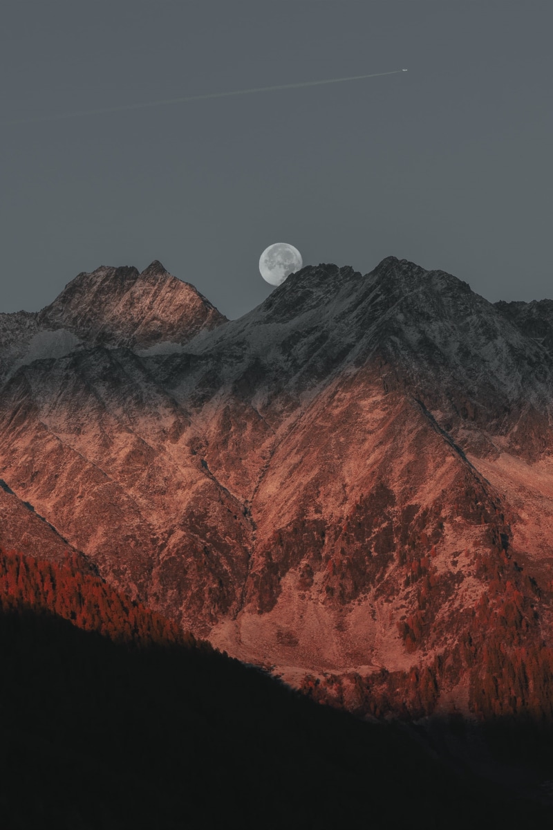 non-urban scene, plane, idyllic, red, rock, tranquility, sunset, nature, mountainside, beauty in nature, hiding, moonlit, mountain peak, astronomy, snow