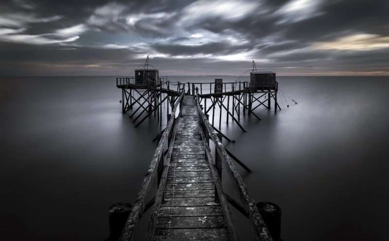 dark, direction, cloud - sky, pier, built structure, tranquil scene, water, moody, horizon over water, railing, architecture, sky, beauty in nature, nature
