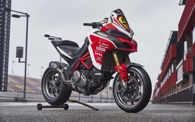 k, safety, Ducati, transportation, air vehicle, airplane, focus on foreground, sign, road, protection, sky, stationary, land vehicle, architecture, day