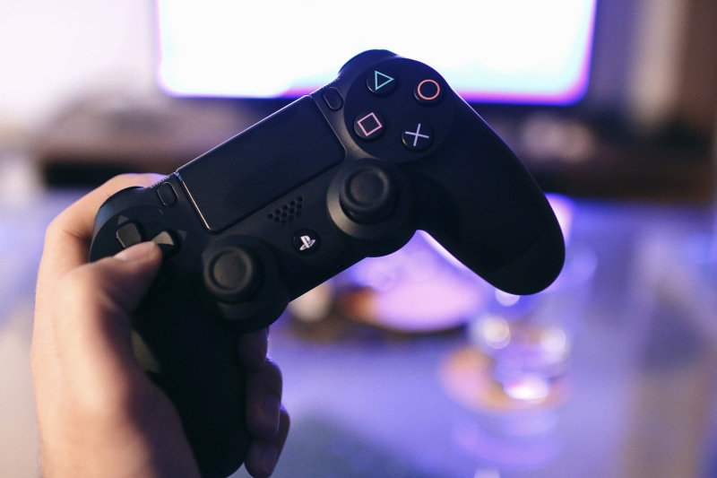 hand, television set, gamer, safety, handgun, human finger, one person, gaming, technology, console, men, finger, indoors, controller, playstation, adult