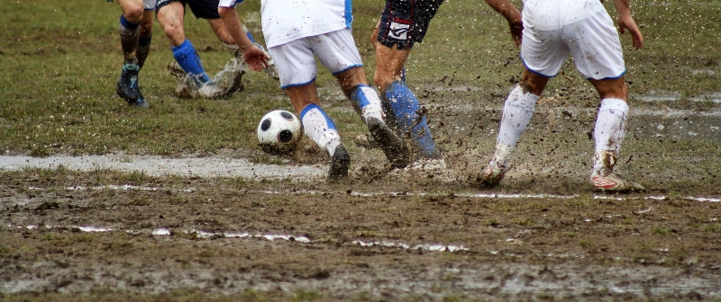 mud, human body part, field, player, motion, sport, grass, group of people, team sport, active, bad field, low section, fun, football, soccer player, soccer ball