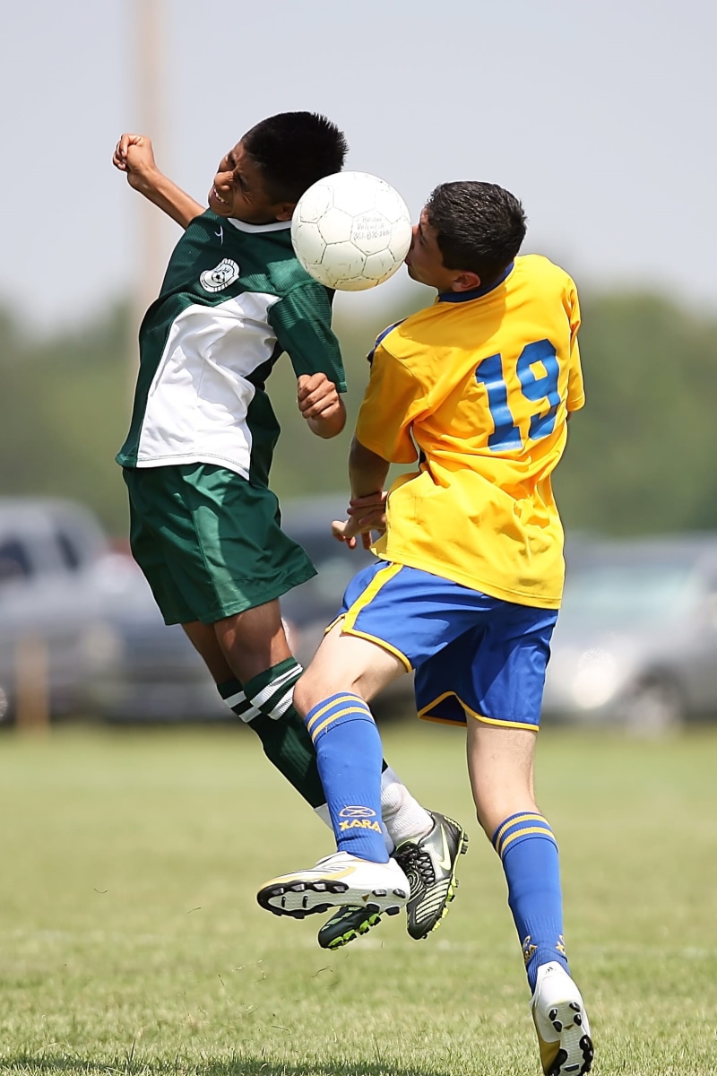 Football, heading, teamwork, motion, field, activity, rivalry, player, youth, competitive Sport, players, sports Uniform, men, playing, people, boy, real people